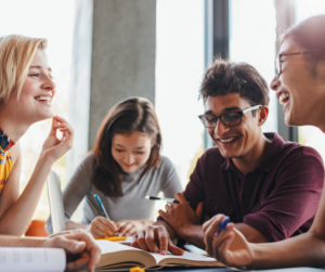 students talking at schools around a table