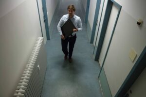 employee walking down a corridor with a package